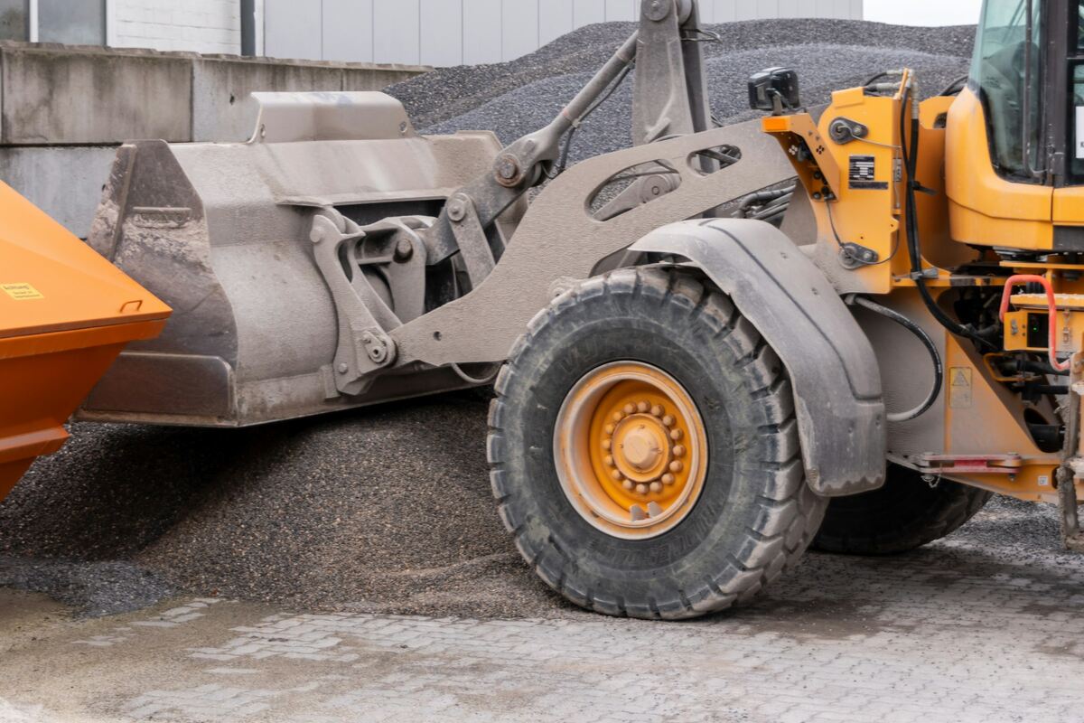 A wheel loader working a pile of crushed gravel